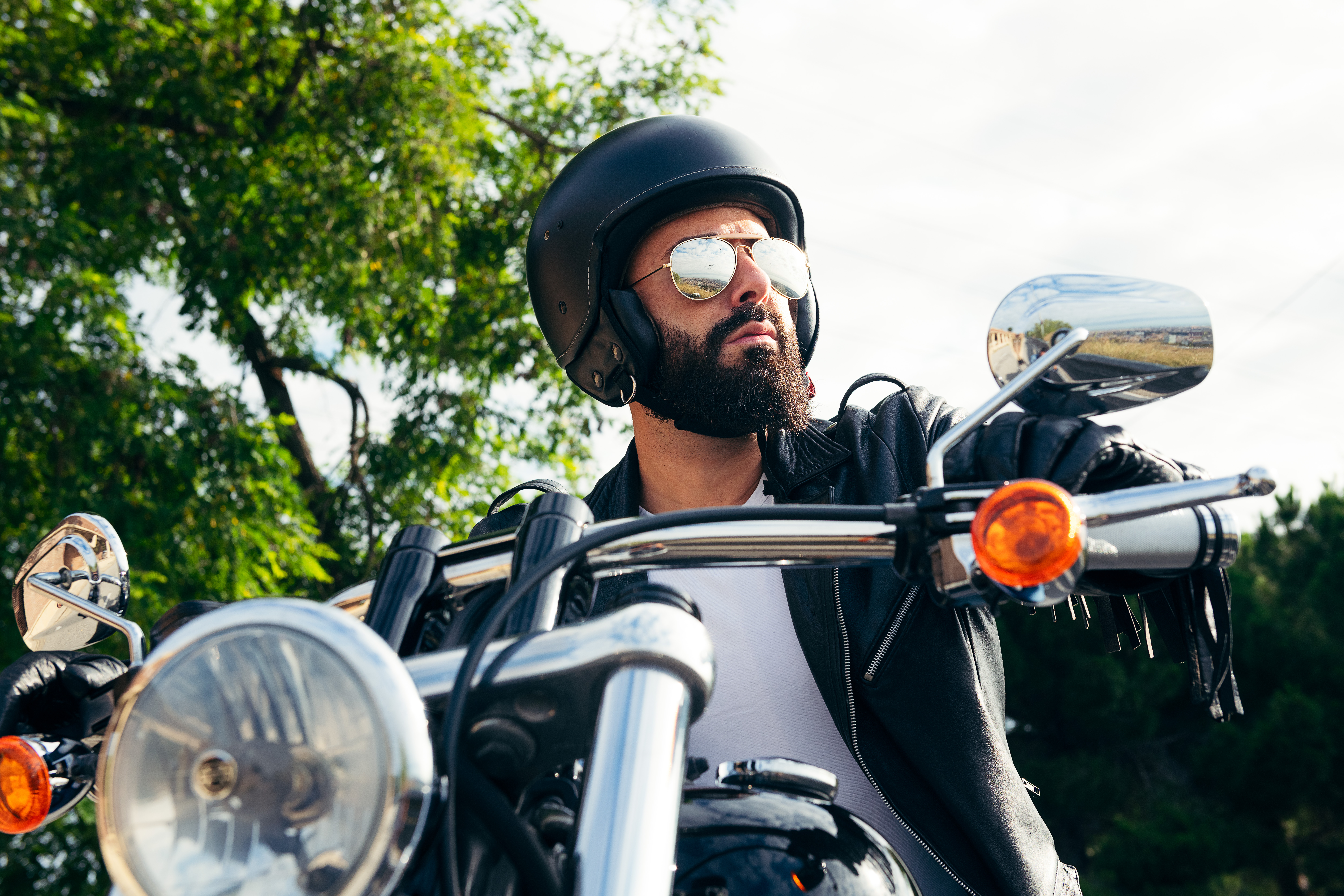 man with helmet and sunglasses riding a motorcycle