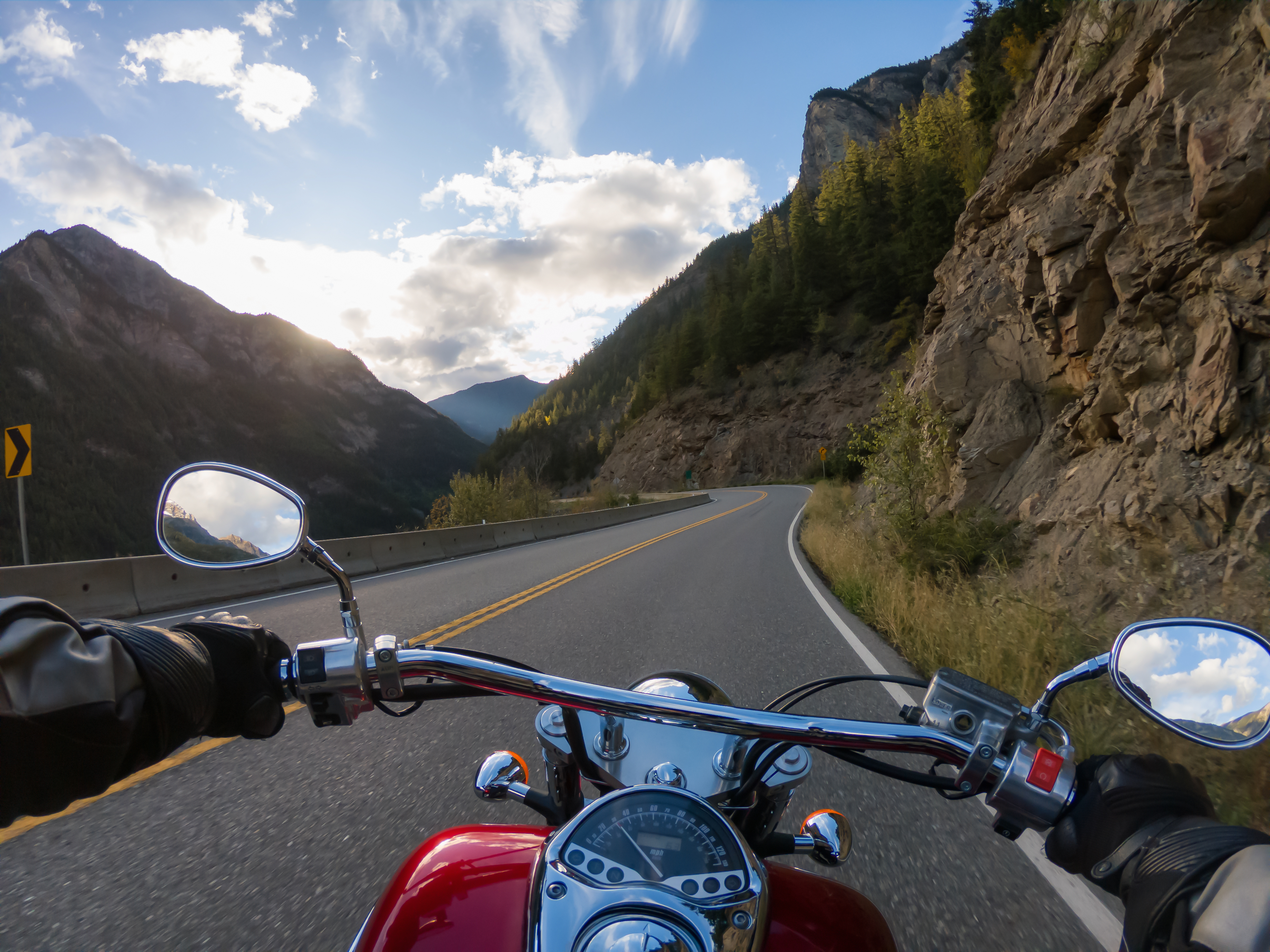 Riding on a motorcycle on a scenic road surrounded by the Canadian Mountains
